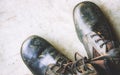 Old black leather shoes on the floor. Pair of old dirty black leather shoes Royalty Free Stock Photo