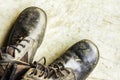 Old black leather shoes on the floor. Pair of old dirty black leather shoes Royalty Free Stock Photo