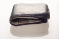 Old black leather wallet with a pair of bills and credit cards Royalty Free Stock Photo