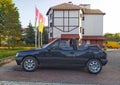 Old classic black little cabrio black car Peugeot 205 convertible parked Royalty Free Stock Photo