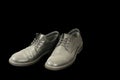 Old black men dusty leather shoes isolated on black background, unemployment concept Royalty Free Stock Photo