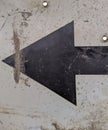 old and black metal arrow sign points to the left Royalty Free Stock Photo