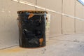 Old, black metal bucket, dented and rusty, closeup