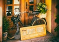 Old black moped in a shop window in historic Colmar in the Little Venice district