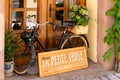 Old black moped in a shop window in historic Colmar in the Little Venice district