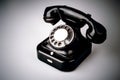 Old black phone with dust and scratches on white background Royalty Free Stock Photo