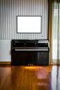 Old Black Piano with White Empty Board Above It Royalty Free Stock Photo