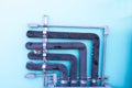 Old black plastic refrigerant pipe air attached to blue building wall. Royalty Free Stock Photo