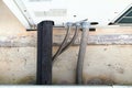 Old black plastic refrigerant pipe air connected to the back of a large air conditioner. Royalty Free Stock Photo