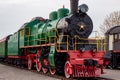 Old black and red retro steam locomotive at the railway station. Vintage train staying on the railroad. Royalty Free Stock Photo