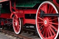 Old black and red retro steam locomotive wheels at the railway station. Vintage train staying on the railroad. Royalty Free Stock Photo