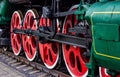 Old black and red retro steam locomotive wheels at the railway station. Vintage train staying on the railroad. Royalty Free Stock Photo