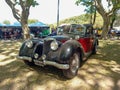 Old black and red 1943 Riley RMB 2.5 in a park. Nature, trees. Autoclasica 2022 classic car show Royalty Free Stock Photo