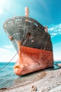 An old black-and-red ship that anchored and ran aground. The bow of the ship close-up. View from the bow of the ship. Blue Sea and Royalty Free Stock Photo