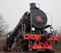 Old black and red soviet steam locomotive with red star in front