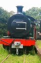 OLD BLACK AND RED STEAM LOCOMOTIVE ABANDONED ON AN UNUSED RAIL Royalty Free Stock Photo