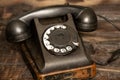 Old black retro phone on a wooden table, rotary phone Royalty Free Stock Photo