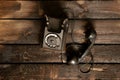 Old black retro phone on a wooden table, rotary phone Royalty Free Stock Photo