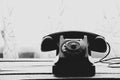 Old black retro phone on a wooden table, rotary phone Royalty Free Stock Photo