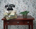 Old black rotary dial telephone on stack of phone books Royalty Free Stock Photo