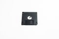 Old black, single, three and a half floppy disk on white background