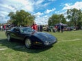 Old black sport 1980s Chevrolet Corvette C4 coupe hardtop in the countryside. Classic muscle car