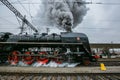 Old black steam engine with red wheels