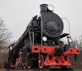 Old black steam locomotive with red decoration Royalty Free Stock Photo