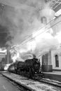 Old black steam locomotive in Russia in the winter on the background of the Moscow railway station Royalty Free Stock Photo