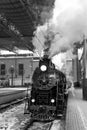 Old black steam locomotive in Russia in the winter on the background of the Moscow railway station Royalty Free Stock Photo