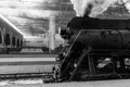 Old black steam locomotive in Russia in the winter on the background of the Moscow railway station Royalty Free Stock Photo