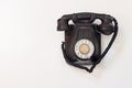 Old black telephone hanging on a white wall Royalty Free Stock Photo