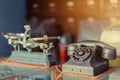 The old black telephone with rotary dial with dust and scratches placed on a clear glass cabinet Royalty Free Stock Photo