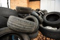 old black used car tires heaped with leaves
