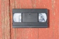 Old black VHS video tipe cassette on the red wooden floor Royalty Free Stock Photo