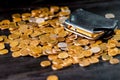 An old black wallet sits on top of a pile of Russian coins. The concept of inflation and poverty