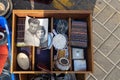 Old black and white photo of a husband and wife in a box with different things at a flea market