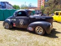 Old black 1941 Willys Americar coupe hot rod dragster in a park. Autoclasica 2022 classic car show