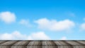 Old black wooden table with blurred of blue sky with clouds on background - For product display. Royalty Free Stock Photo