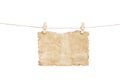 Old blank brown paper texture with burned edges patterns hanging in wood clothes pins and brown rope isolated on white background Royalty Free Stock Photo