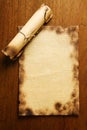 Old blank paper and scroll on wooden table Royalty Free Stock Photo