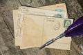 Old blank vintage postcard with old stamp is on old wood with nib Royalty Free Stock Photo
