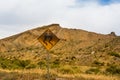 Old blistered slippery when wet sign in the desert