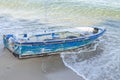 Old blue abandoned fishing boat on the sand beach Royalty Free Stock Photo