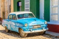 Old blue american retro car parked on the street of Trinidad, Cuba Royalty Free Stock Photo