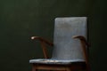 Old blue armchair on green background with copy space Royalty Free Stock Photo