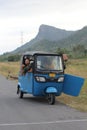 Old  Blue Bajaj on a quiet road Royalty Free Stock Photo