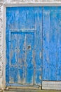 Old blue barn door in the countryside. Closed shabby vintage entrance to the village yard Royalty Free Stock Photo