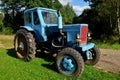 Old blue Belarus tractor on a farm.