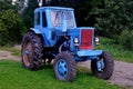 Old blue Belarus tractor on a farm.